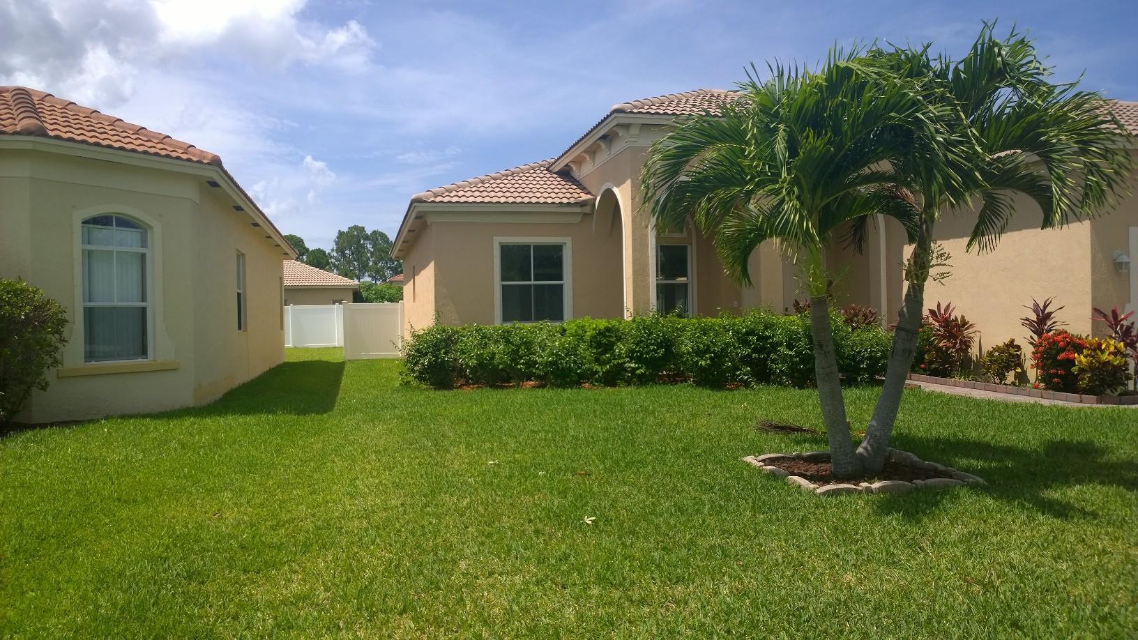 5949 Spanish River Road Fort Pierce, FL 34951 - Photo 2 of 43 a front view of a house with garden