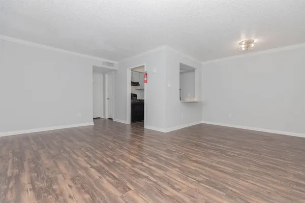 a view of empty room with wooden floor and cabinet