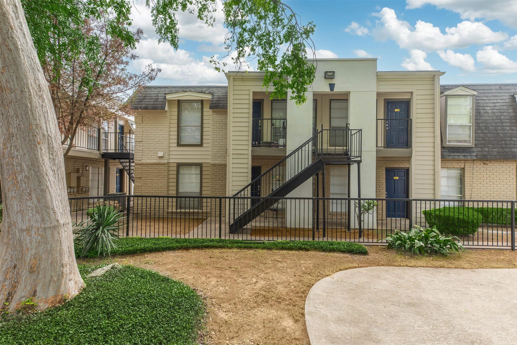 3001 Hillcroft Street, Unit G1208 Houston, TX 77057 - Photo 44 of 50 a view of a white house with large windows and a small yard