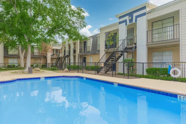 a view of an house with swimming pool and porch