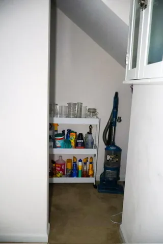a living room with a flat screen tv and white cabinet