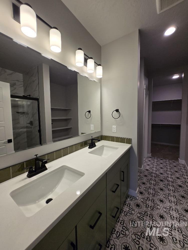 10400 Bellevue Ridge Street Nampa, ID 83687 - Photo 14 of 27 Full bathroom featuring a walk in closet, double vanity, a marble finish shower, and recessed lighting