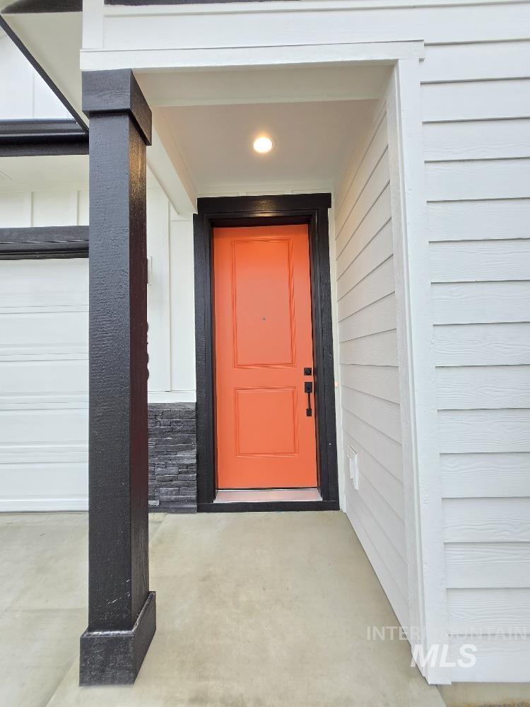 10400 Bellevue Ridge Street Nampa, ID 83687 - Photo 2 of 27 View of exterior entry with a porch and a garage