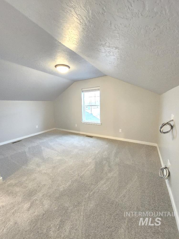 10400 Bellevue Ridge Street Nampa, ID 83687 - Photo 22 of 27 Bonus room with a textured ceiling, carpet flooring, and vaulted ceiling