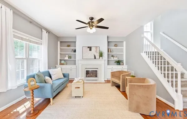 a living room with furniture and a fireplace