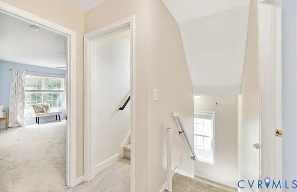 a view of a hallway with wooden floor and entryway