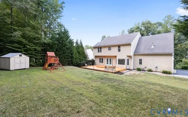 a view of a house with backyard and sitting area