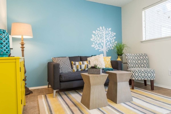 a living room with furniture and a lamp