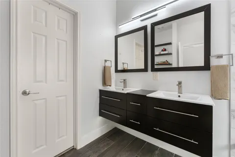 a bathroom with a sink vanity and a mirror
