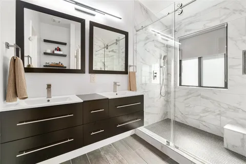 a bathroom with a sink double vanity and a mirror