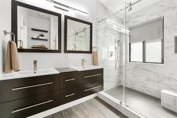 a bathroom with a sink double vanity and a mirror
