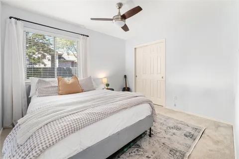 a bedroom with a large bed and a window