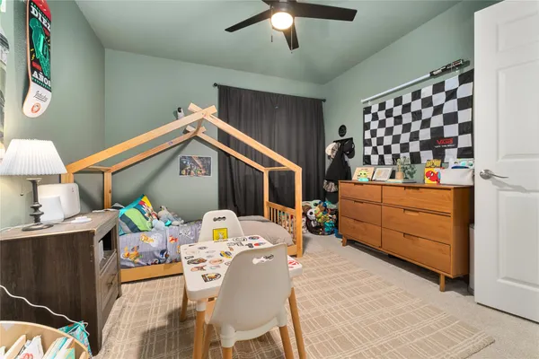 a view of a dining room with a table and chairs