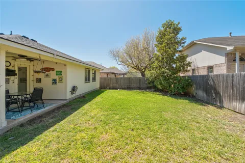 a view of backyard with patio