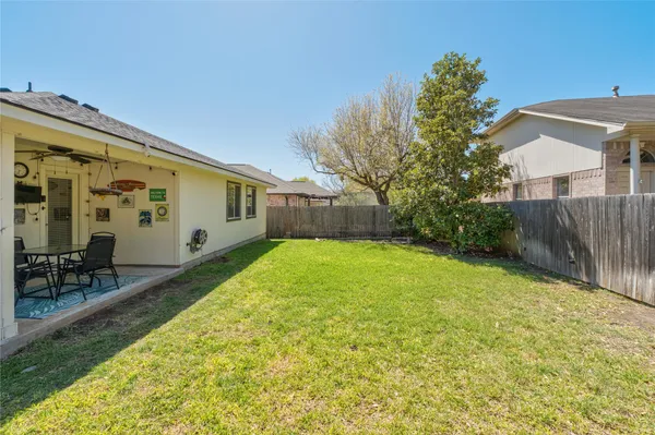a view of backyard with patio