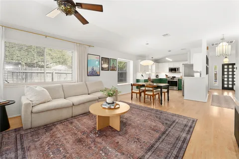 a living room with furniture a rug and a large window