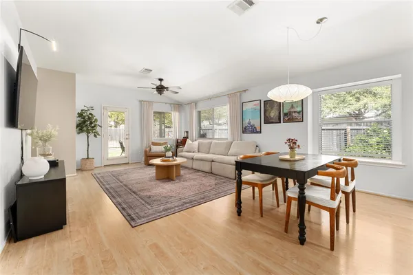 a living room with furniture a table and a large window