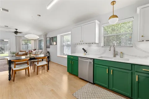 a kitchen with a table chairs sink and cabinets
