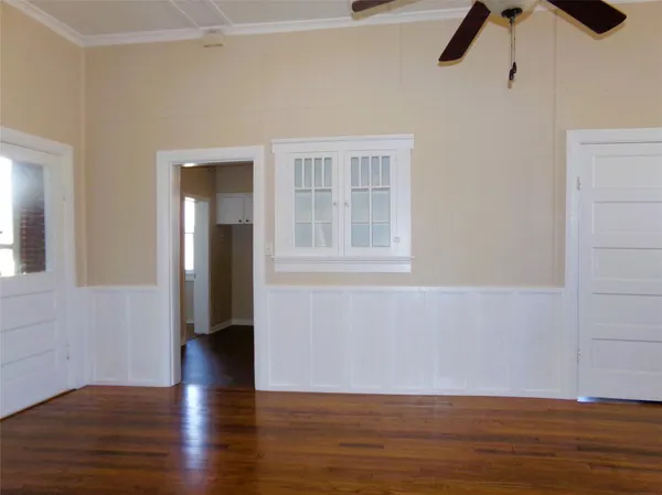 a view of a livingroom with wooden floor and a fireplace
