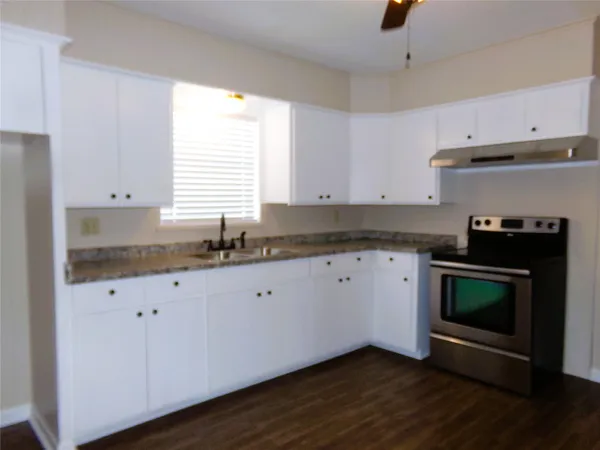 a kitchen with stainless steel appliances a stove a sink and a microwave