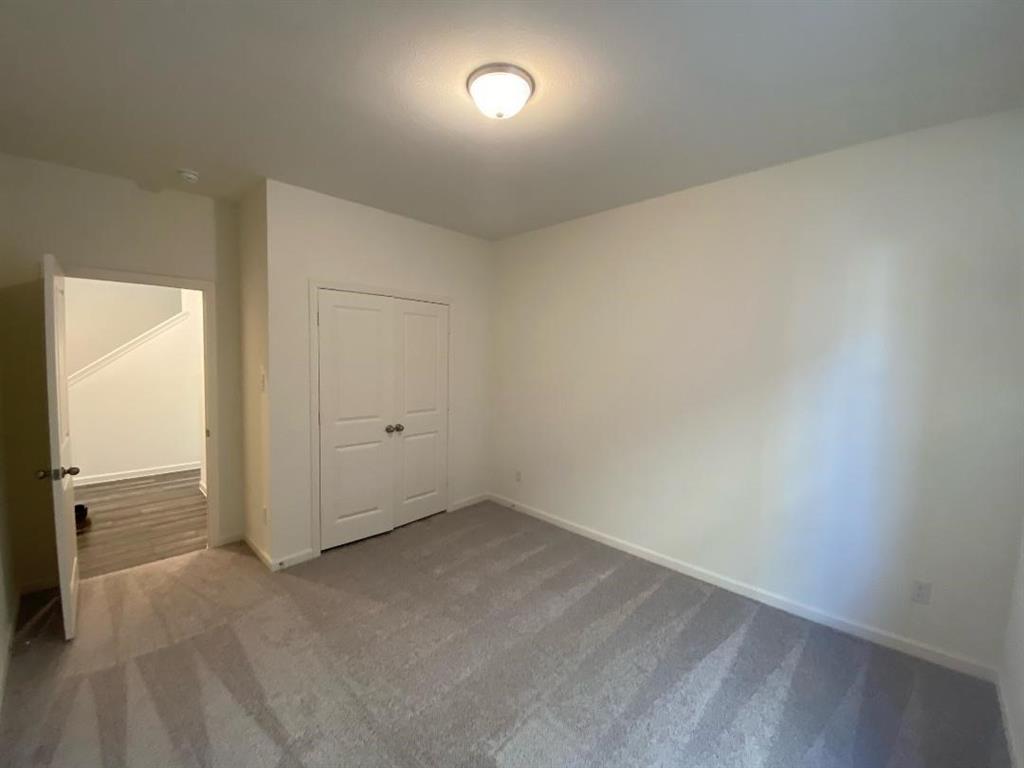 623 Colgate Circle Princeton, TX 75407 - Photo 7 of 15 Neutral-toned room featuring light gray patterned carpeting