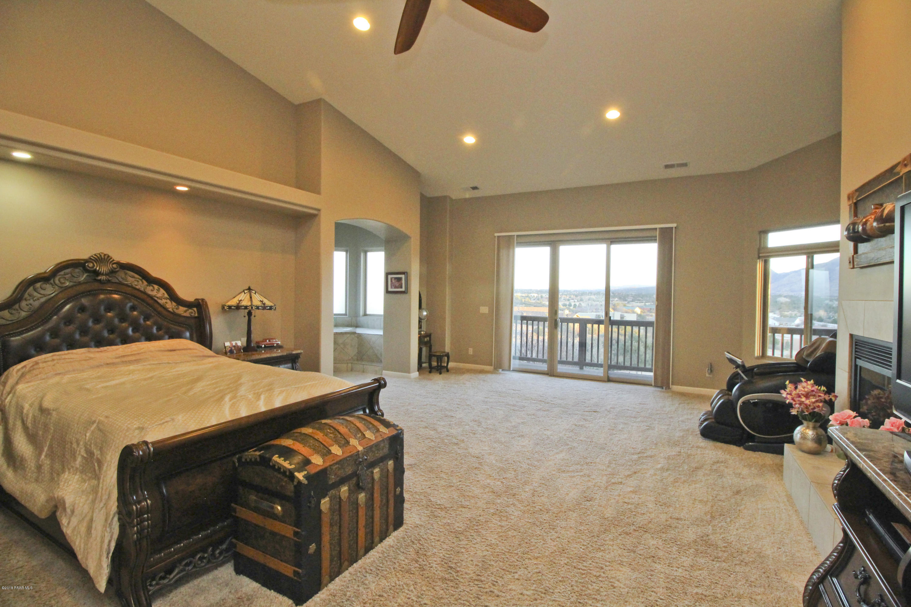 4800 West Mint Creek Road Prescott, AZ 86305 - Photo 11 of 62 a spacious bedroom with a bed a table and large windows