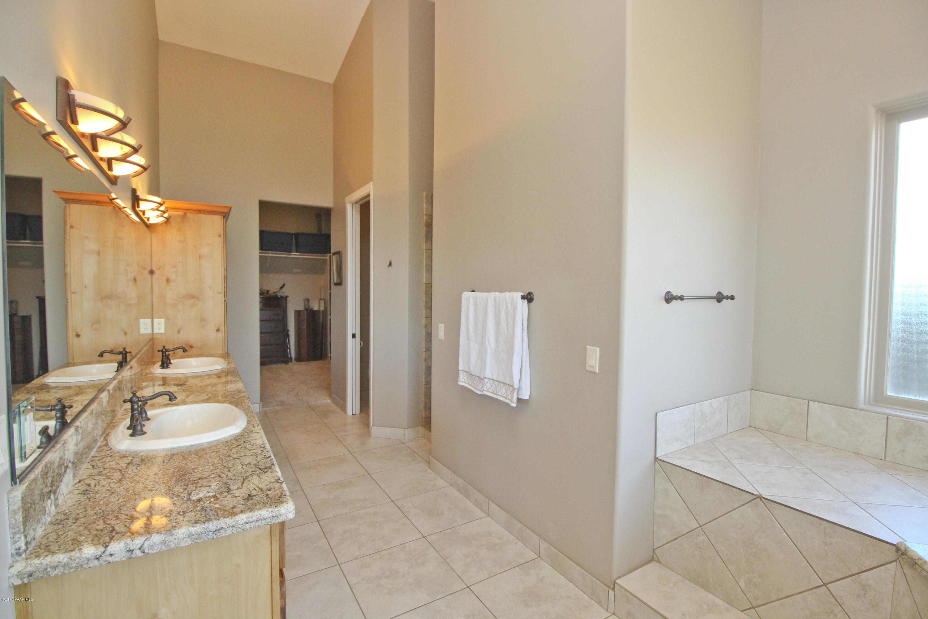 4800 West Mint Creek Road Prescott, AZ 86305 - Photo 15 of 62 a spacious bathroom with a granite countertop sink a mirror and shower