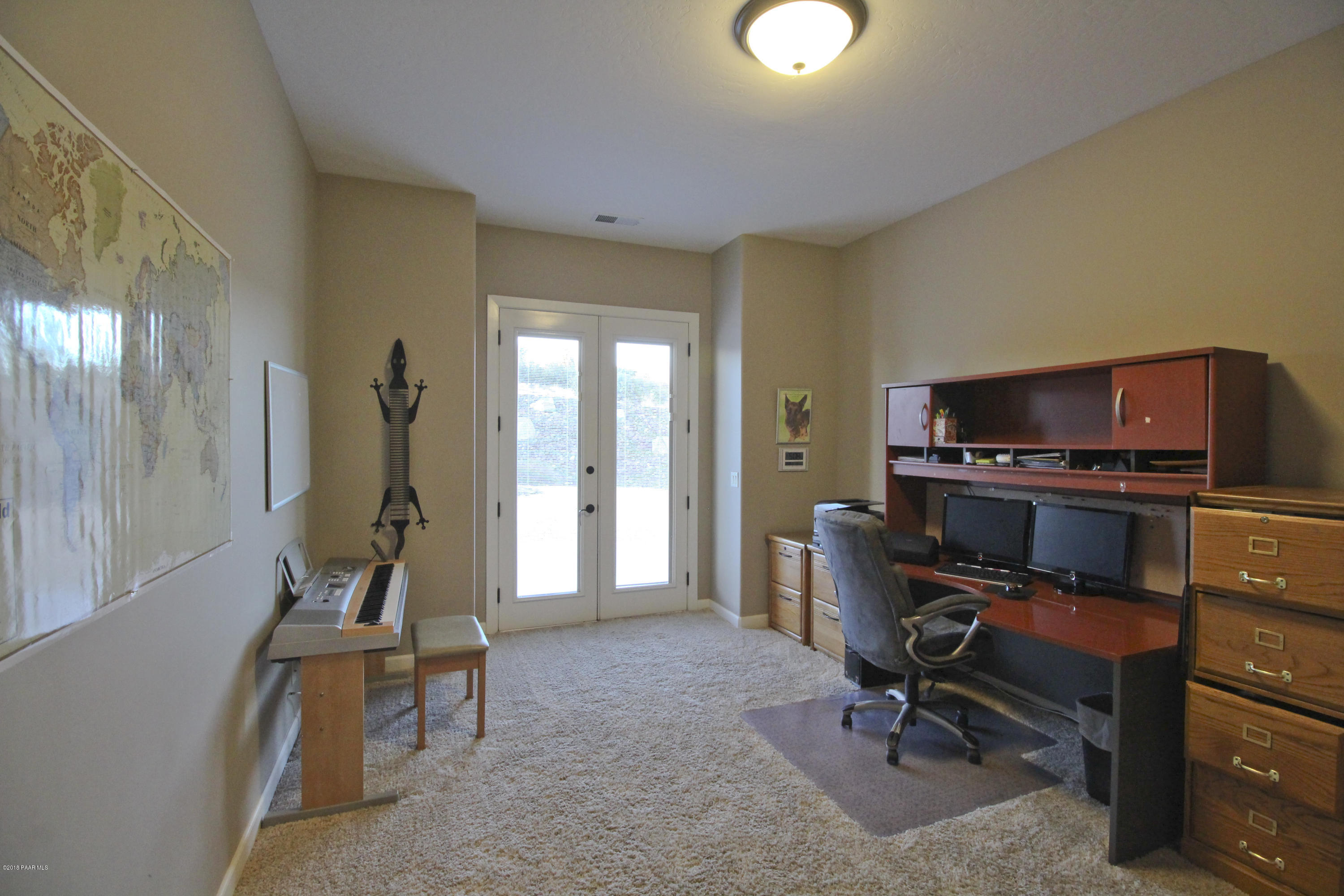 4800 West Mint Creek Road Prescott, AZ 86305 - Photo 18 of 62 a view of a workspace with furniture and a window
