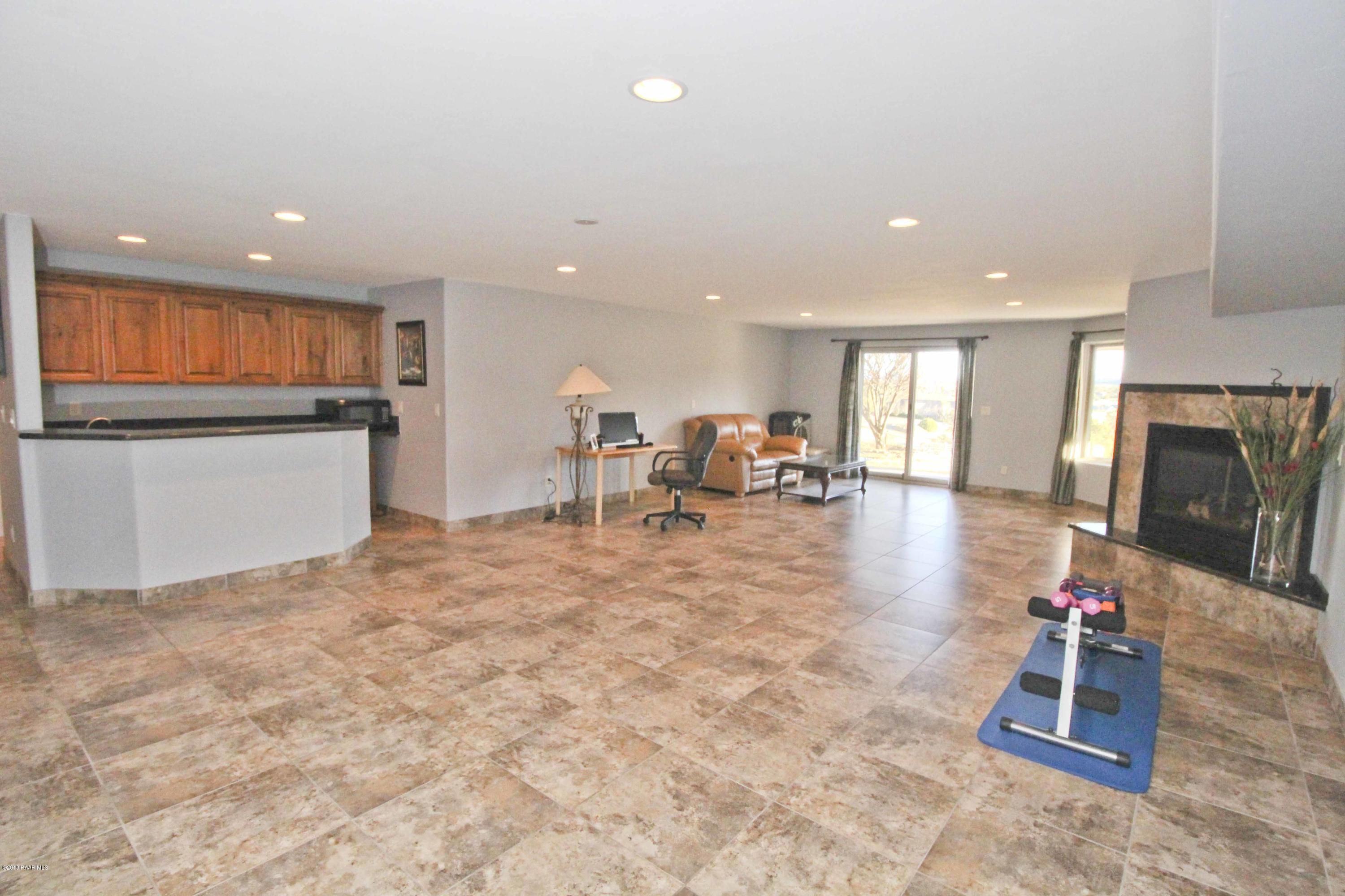 4800 West Mint Creek Road Prescott, AZ 86305 - Photo 25 of 62 a living room with furniture a flat screen tv and a dining table
