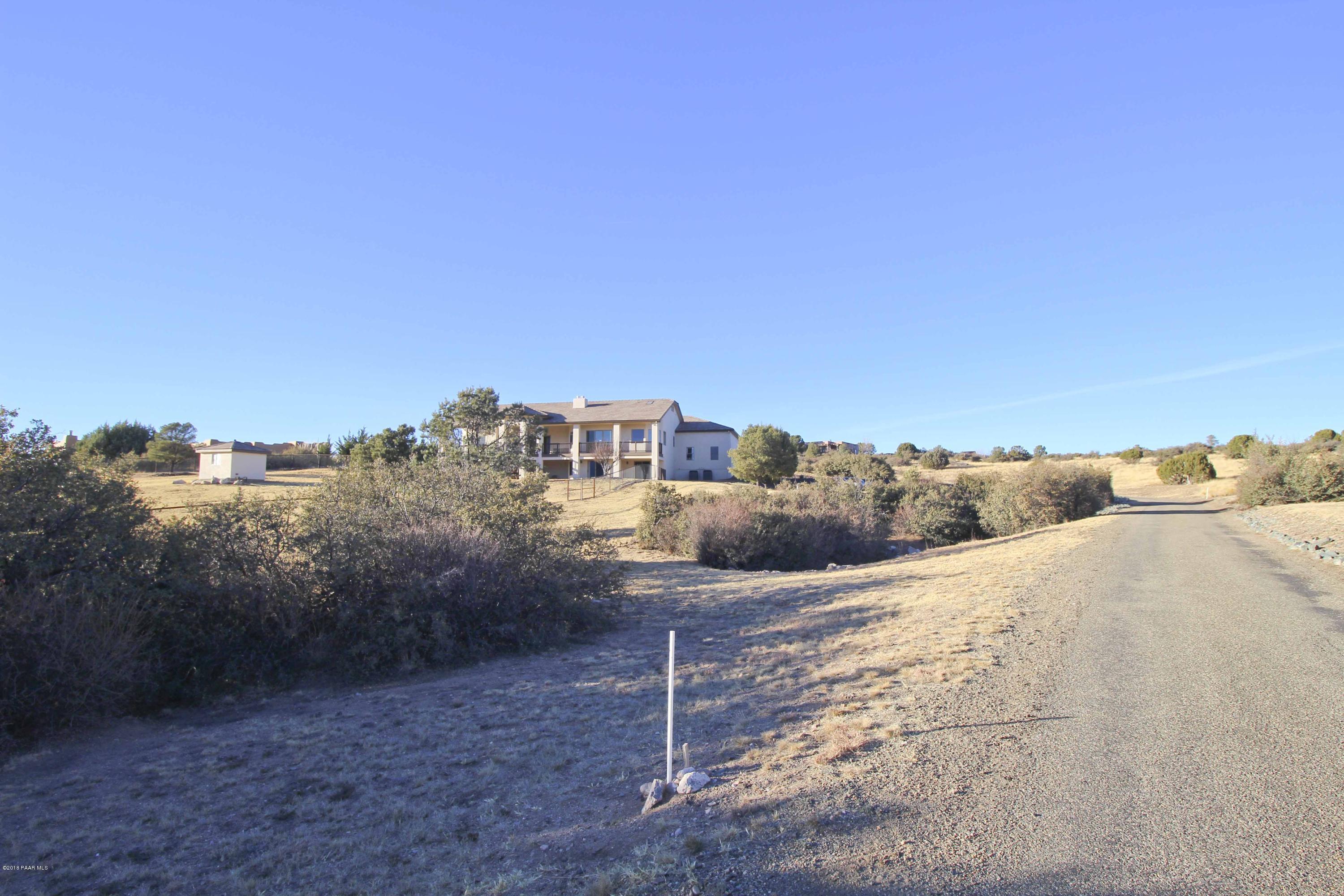 4800 West Mint Creek Road Prescott, AZ 86305 - Photo 36 of 62 a view of a dry yard with wooden fence