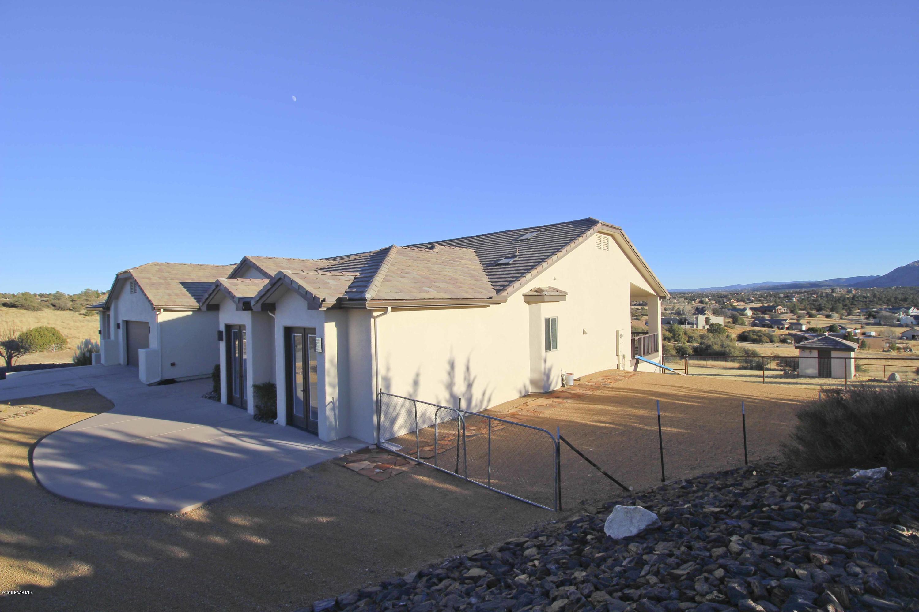 4800 West Mint Creek Road Prescott, AZ 86305 - Photo 43 of 62 a backyard of a house with table and chairs