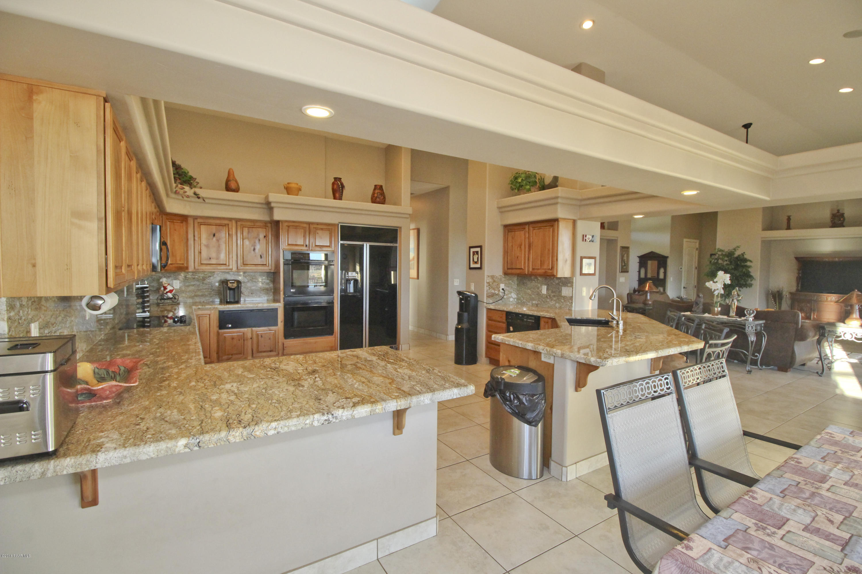 4800 West Mint Creek Road Prescott, AZ 86305 - Photo 8 of 62 a large kitchen with lots of counter top space and living room