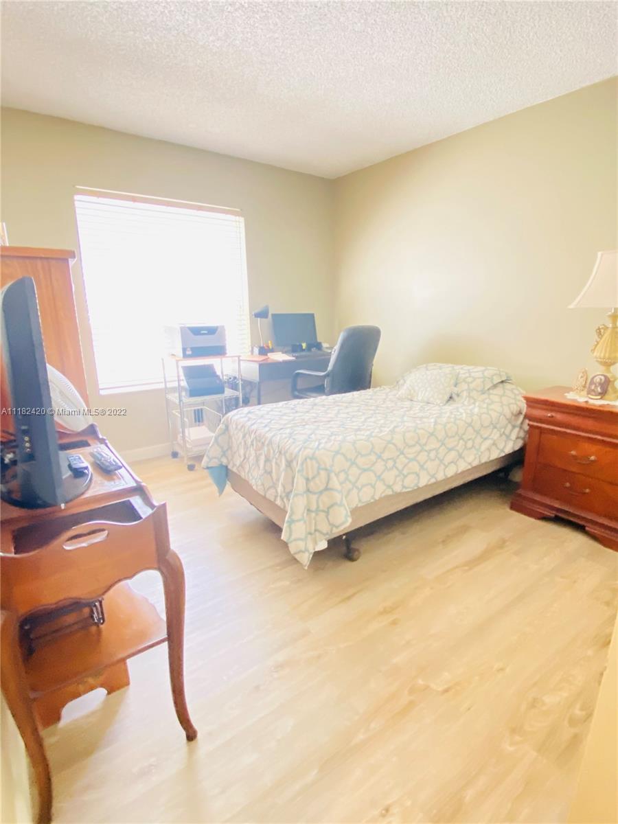944 Falling Water Road Weston, FL 33326 - Photo 18 of 37 a spacious bedroom with a bed and window