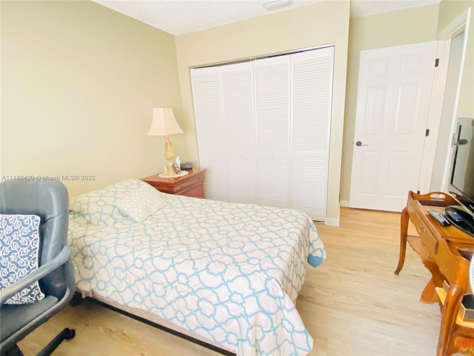 944 Falling Water Road Weston, FL 33326 - Photo 20 of 37 a bedroom with a bed and a window
