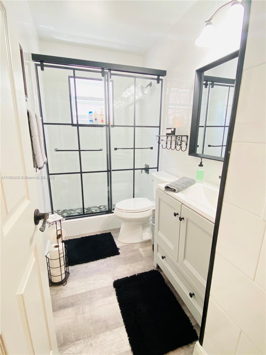 944 Falling Water Road Weston, FL 33326 - Photo 21 of 37 a bathroom with a sink toilet and shower