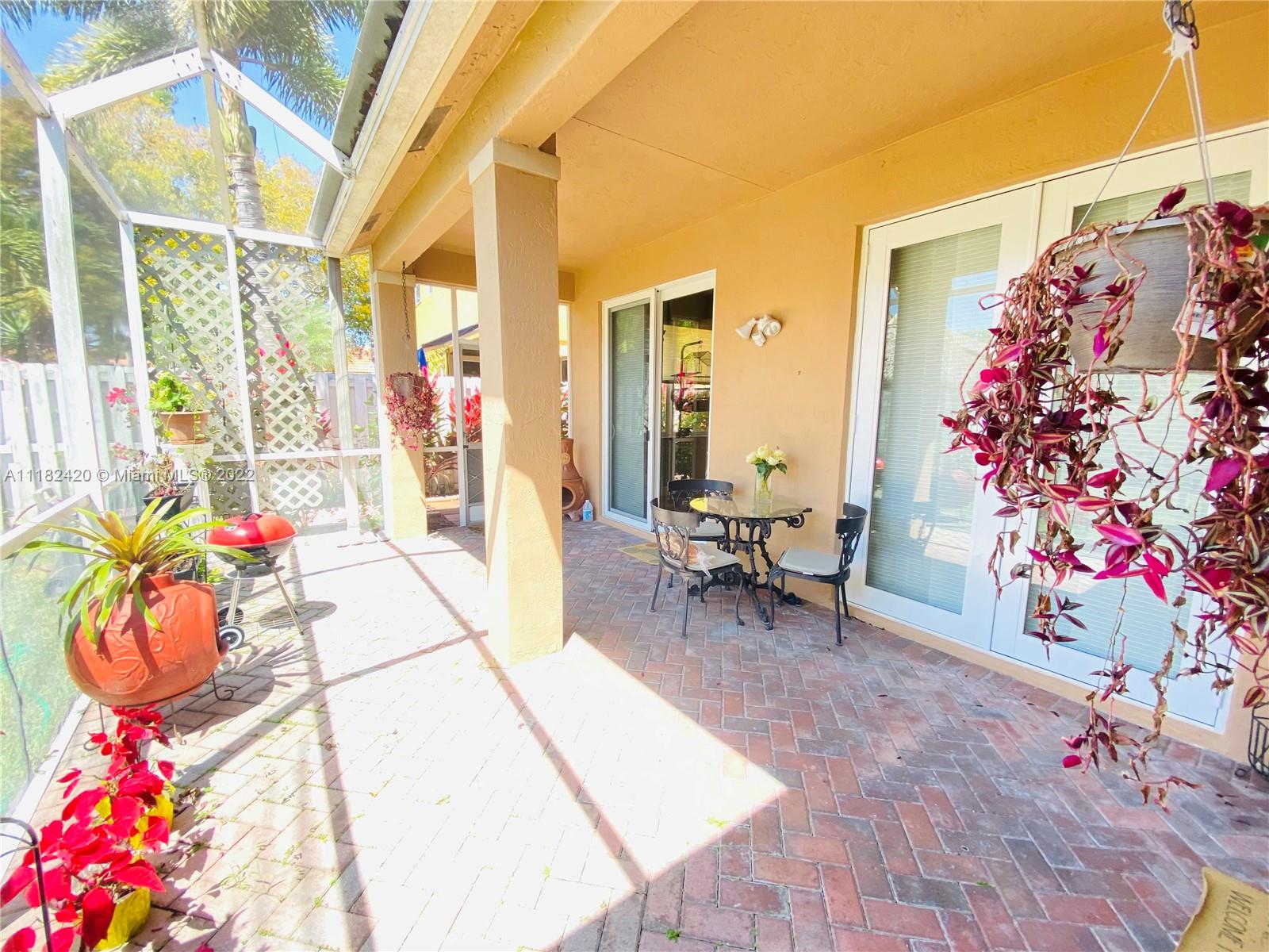 944 Falling Water Road Weston, FL 33326 - Photo 27 of 37 a living room with furniture and flowers
