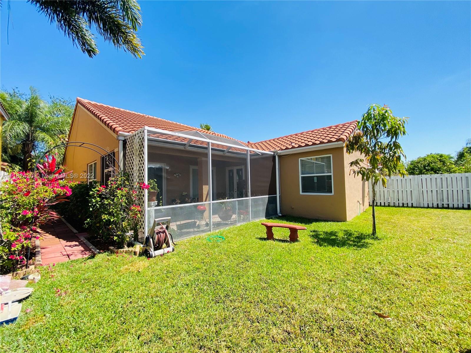 944 Falling Water Road Weston, FL 33326 - Photo 29 of 37 a view of backyard with swimming pool and porch