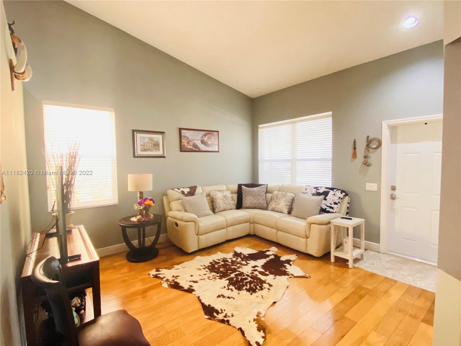 944 Falling Water Road Weston, FL 33326 - Photo 5 of 37 a living room with furniture window and a table
