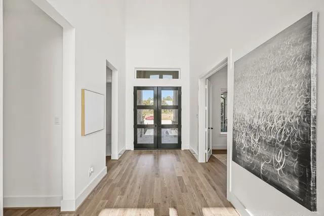 a dining room with furniture wooden floor a chandelier
