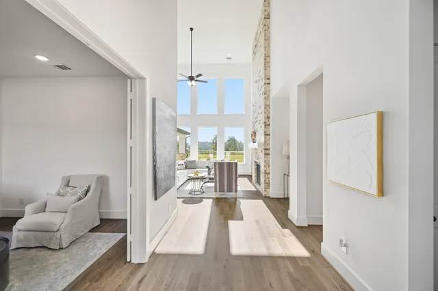 a large kitchen with kitchen island a large counter top space a sink appliances and living room view