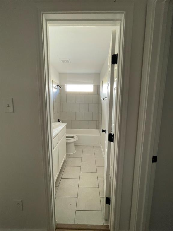 212 Mineral Wells Street Terrell, TX 75160 - Photo 12 of 16 a bathroom with a glass shower door and a toilet