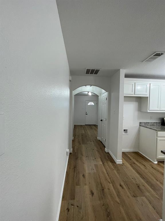 212 Mineral Wells Street Terrell, TX 75160 - Photo 2 of 16 a view of a kitchen with wooden floor and a sink