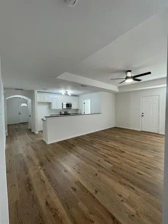 a view of a kitchen with a sink and cabinets