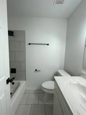 a bathroom with a toilet and a bathtub