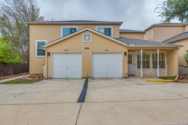 a view of a house with a yard and garage