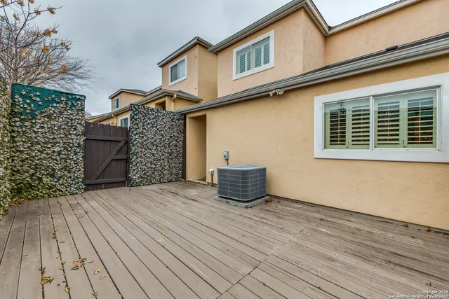 a front view of a house with a wooden fence