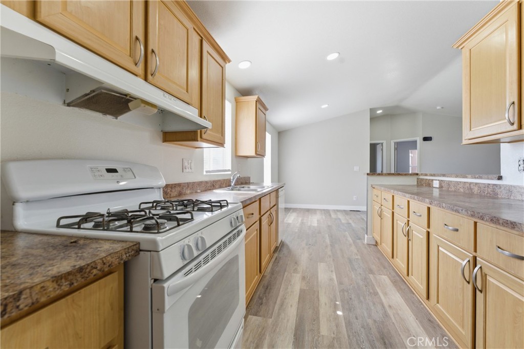 20843 Waalew Road, Unit C125 Apple Valley, CA 92307 - Photo 8 of 38 a kitchen with stainless steel appliances granite countertop a stove and a sink