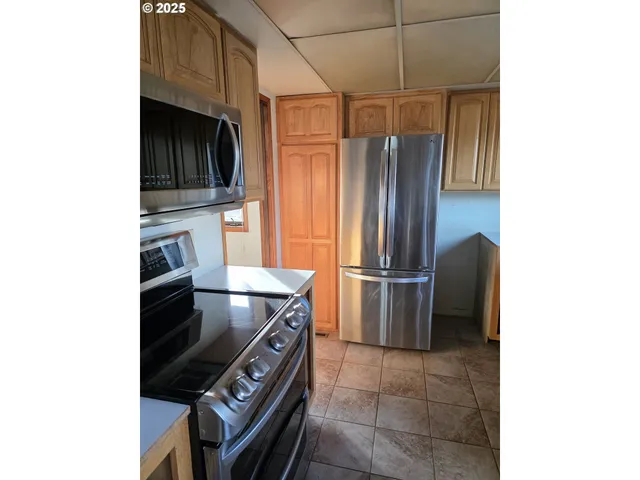 a kitchen with stainless steel appliances a refrigerator and a stove