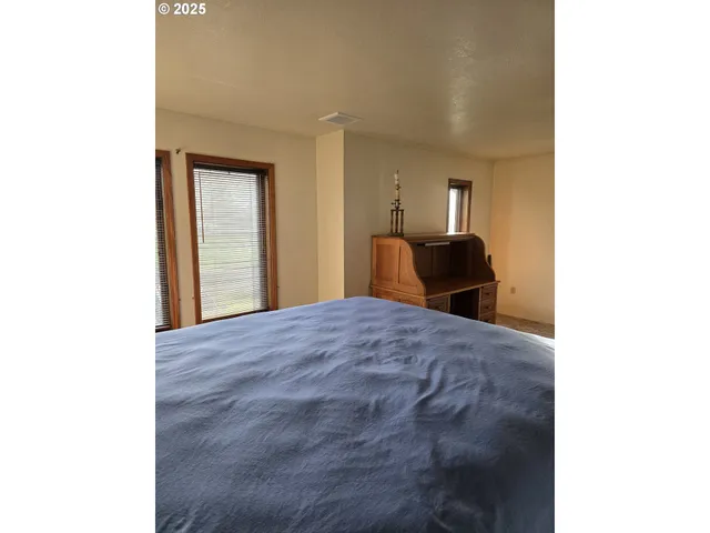 a bedroom with a bed and a mirror