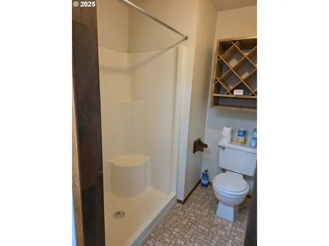 a bathroom with a toilet and a shower